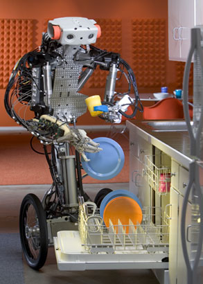 Monty - Monty was great to work with! We had an emergency when he fell down and broke his hand. Luckily, an Anybot engineer was standing by to manufacture another one on the spot. In this shot, Monty is loading the dishwasher. Something his mother and creator always wanted him to do.